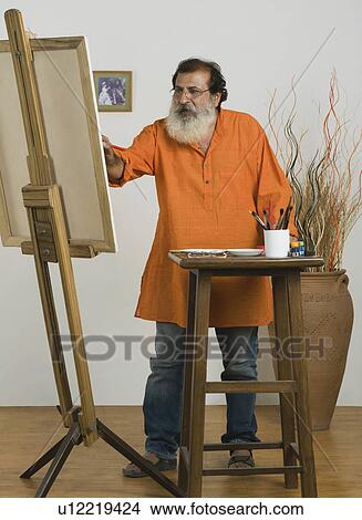 Man painting on a canvas View Large Photo Image Picture - Man painting on a canvas. Fotosearch