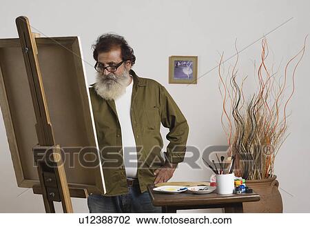 Man painting on a canvas View Large Photo Image Stock Image - Man painting on a canvas. Fotosearch