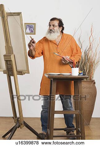 Man painting on a canvas View Large Photo Image Stock Photo - Man painting on a canvas. Fotosearch
