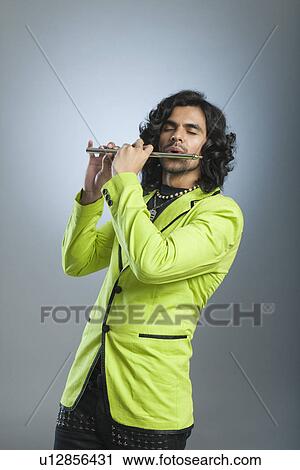 Man playing a flute View Large Photo Image Stock Image - Man playing a flute. Fotosearch
