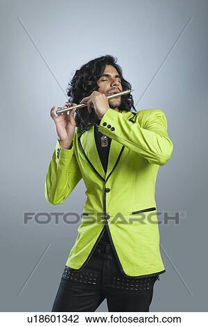 Stock Image - Man playing a flute. Fotosearch