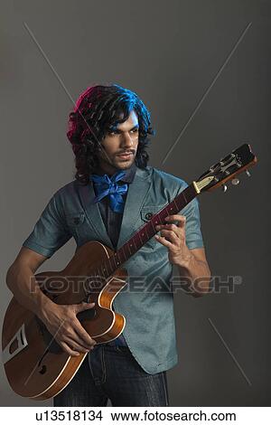 Man playing a guitar View Large Photo Image Picture - Man playing a guitar. Fotosearch