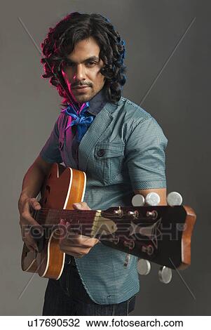 Man playing a guitar View Large Photo Image Stock Image - Man playing a guitar. Fotosearch