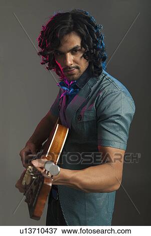 Stock Photo - Man playing a guitar. Fotosearch