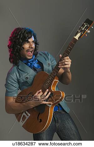 Man playing a guitar View Large Photo Image Stock Photo - Man playing a guitar. Fotosearch