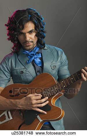 Man playing a guitar View Large Photo Image Stock Photo - Man playing a guitar. Fotosearch