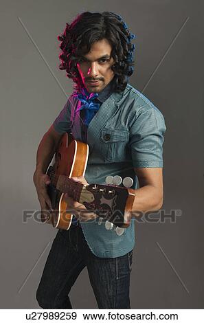 Man playing a guitar View Large Photo Image Stock Photo - Man playing a guitar. Fotosearch