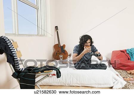 Man playing a video game View Large Photo Image Stock Image - Man playing a video game. Fotosearch