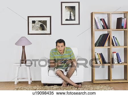 Man playing a video game View Large Photo Image Stock Photography - Man playing a video game. Fotosearch