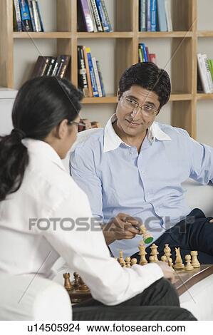 Picture - Man playing chess with his daughter. Fotosearch