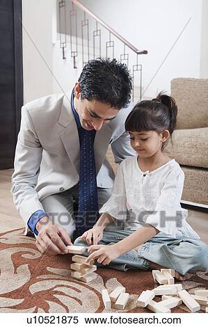 Man playing with his daughter View Large Photo Image Stock Photography - Man playing with his daughter. Fotosearch