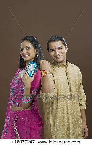 Man showing his rakhi with his sister showing her present View Large Photo Image Stock Photo - Man showing his rakhi with his sister showing her present. Fotosearch