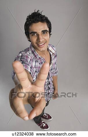 Stock Photo - Man showing victory sign. Fotosearch