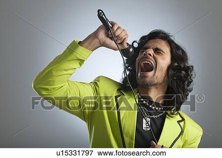 Stock Photo - Man singing into a microphone. Fotosearch