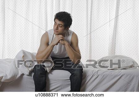 Man sitting on the bed and thinking View Large Photo Image Stock Image - Man sitting on the bed and thinking. Fotosearch