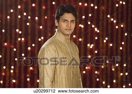 Man smiling in front of Diwali decoration View Large Photo Image Stock Image - Man smiling in front of Diwali decoration. Fotosearch