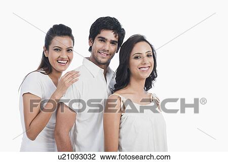 Man smiling with two women View Large Photo Image Stock Image - Man smiling with two women. Fotosearch