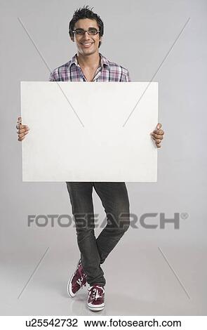 Stock Image - Man standing with a placard. Fotosearch