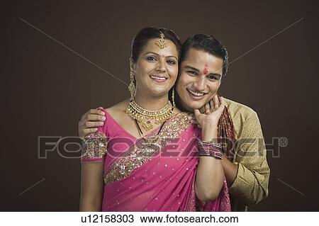 Man standing with his arm around his mother smiling View Large Photo Image Stock Image - Man standing with his arm around his mother smiling. Fotosearch