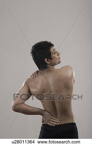 Picture - Man suffering from backache. Fotosearch