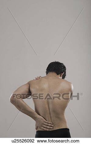 Stock Image - Man suffering from backache. Fotosearch