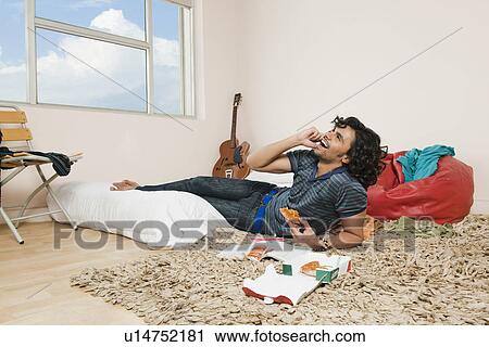Man talking on a mobile phone and laughing View Large Photo Image Stock Image - Man talking on a mobile phone and laughing. Fotosearch