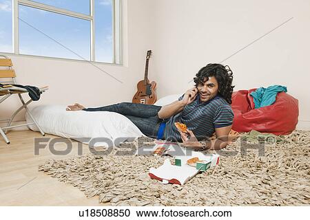 Man talking on a mobile phone and smiling View Large Photo Image Stock Image - Man talking on a mobile phone and smiling. Fotosearch