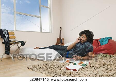 Stock Photography - Man talking on a mobile phone and smiling. Fotosearch