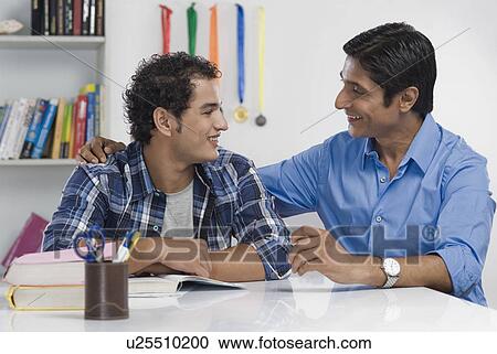 Man talking to his son and smiling View Large Photo Image Stock Image - Man talking to his son and smiling. Fotosearch