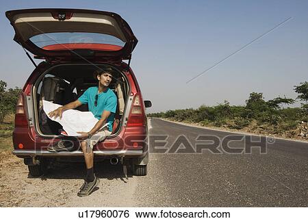 Man with a map in a car View Large Photo Image Stock Photograph - Man with a map in a car. Fotosearch