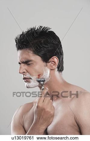 Man with shaving cut with painful expression on face View Large Photo Image Stock Image - Man with shaving cut with painful expression on face. Fotosearch
