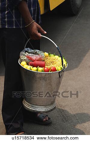 Picture - Market vendor selling snacks, New Delhi, India. Fotosearch