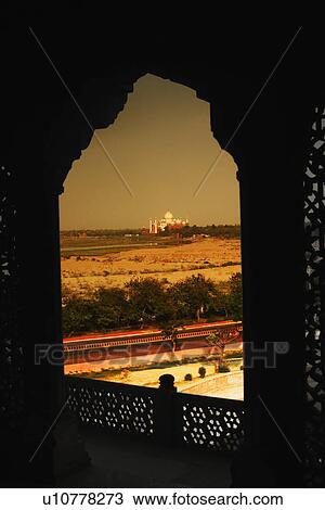 Stock Image - Mausoleum viewed through a balcony of the fort, Agra Fort, Taj Mahal, Agra, Uttar Pradesh, India. Fotosearch