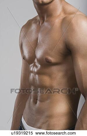 Mid section view of a bare chested man View Large Photo Image Stock Photography - Mid section view of a bare chested man. Fotosearch