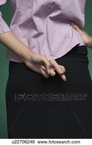 Mid section view of a businesswoman with fingers crossed behind her back View Large Photo Image Stock Photo - Mid section view of a businesswoman with fingers crossed behind her back. Fotosearch