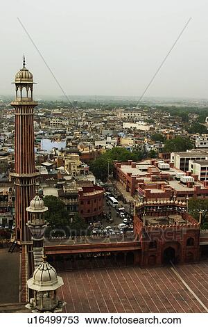 Stock Image - Minaret of a mosque with cityscape, Jama Masjid, Delhi, India. Fotosearch