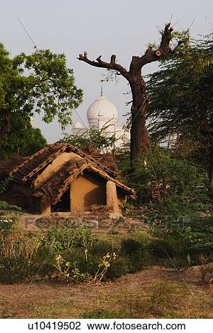 Mud huts with mausoleum in the background, Taj Mahal, Agra, Uttar Pradesh, India View Large Photo Image Stock Image - Mud huts with mausoleum in the background, Taj Mahal, Agra, Uttar Pradesh, India. Fotosearch