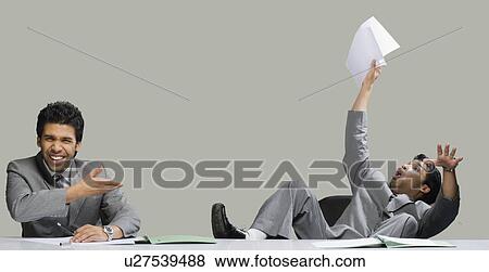 Stock Photo - Multiple images of a businessman in an office. Fotosearch
