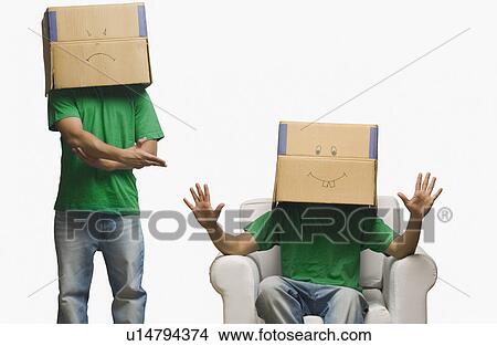 Multiple images of a man covering his face in cardboard boxes View Large Photo Image Picture - Multiple images of a man covering his face in cardboard boxes. Fotosearch