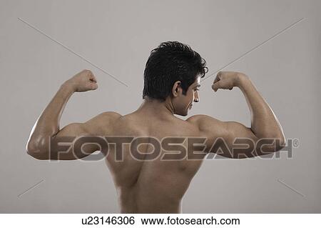 Stock Photograph - Muscular man flexing his biceps. Fotosearch
