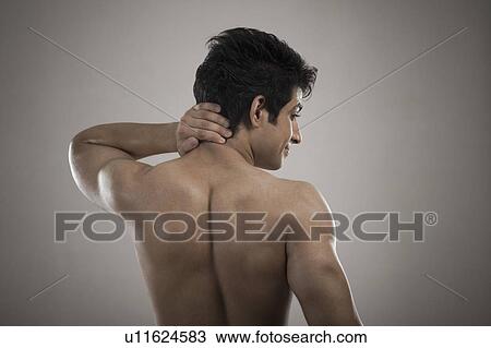 Stock Image - Muscular man suffering from neckache. Fotosearch