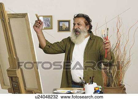 Painter getting excited to look his artwork View Large Photo Image Stock Image - Painter getting excited to look his artwork. Fotosearch