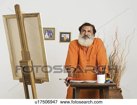 Painter leaning over a table and thinking View Large Photo Image Stock Photo - Painter leaning over a table and thinking. Fotosearch