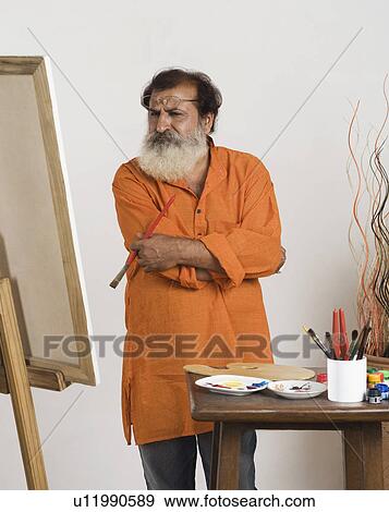 Painter looking at canvas View Large Photo Image Stock Photo - Painter looking at canvas. Fotosearch