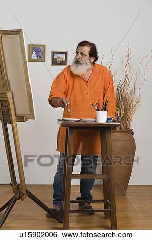 Painter looking at canvas View Large Photo Image Stock Photograph - Painter looking at canvas. Fotosearch