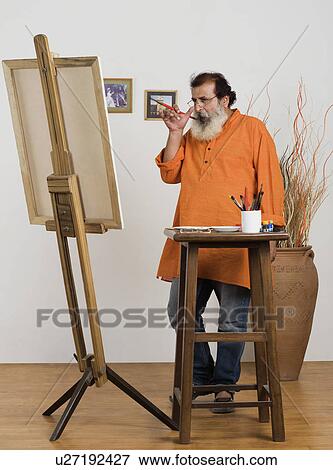 Painter looking at his painting View Large Photo Image Stock Photo - Painter looking at his painting. Fotosearch