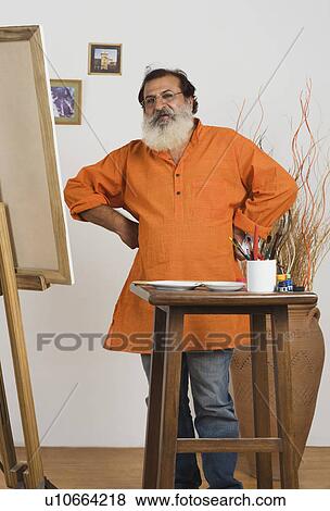 Painter standing with his arms akimbo View Large Photo Image Stock Photo - Painter standing with his arms akimbo. Fotosearch