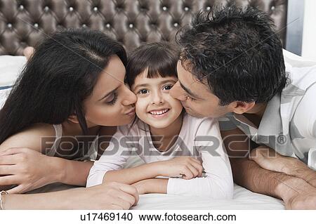 Parents kissing their daughter View Large Photo Image Stock Image - Parents kissing their daughter. Fotosearch