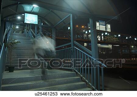 Stock Image - People moving up on steps of a footbridge, National Highway 8, Gurgaon, Haryana. Fotosearch
