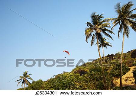Person paragliding over a hill, Goa, India View Large Photo Image Stock Image - Person paragliding over a hill, Goa, India. Fotosearch